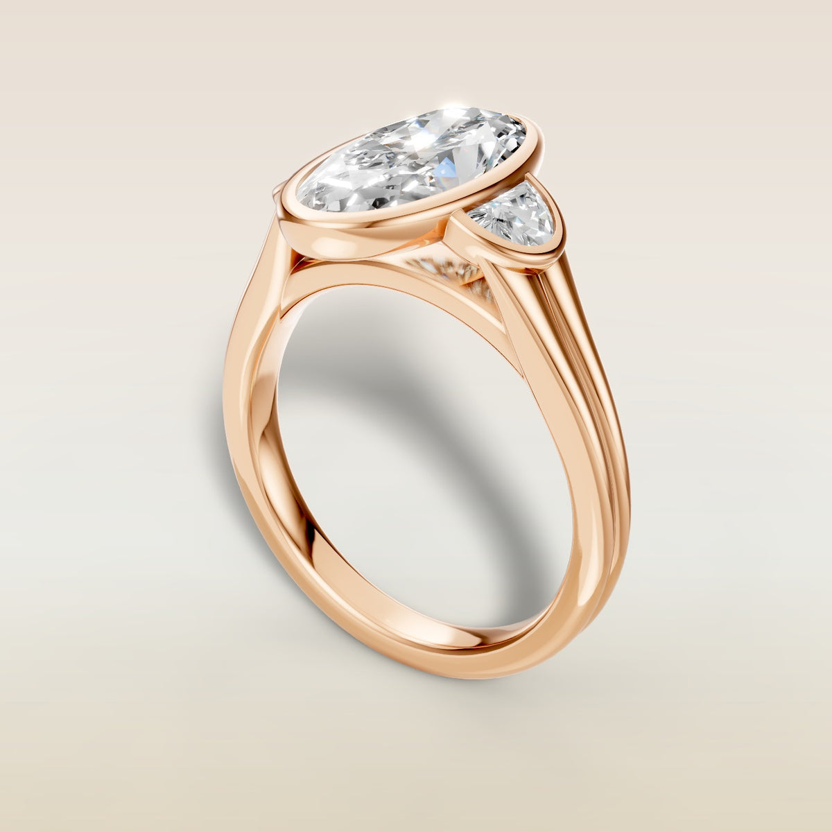Moval Three Stone Full Bezel engagement ring in rose gold, angled view