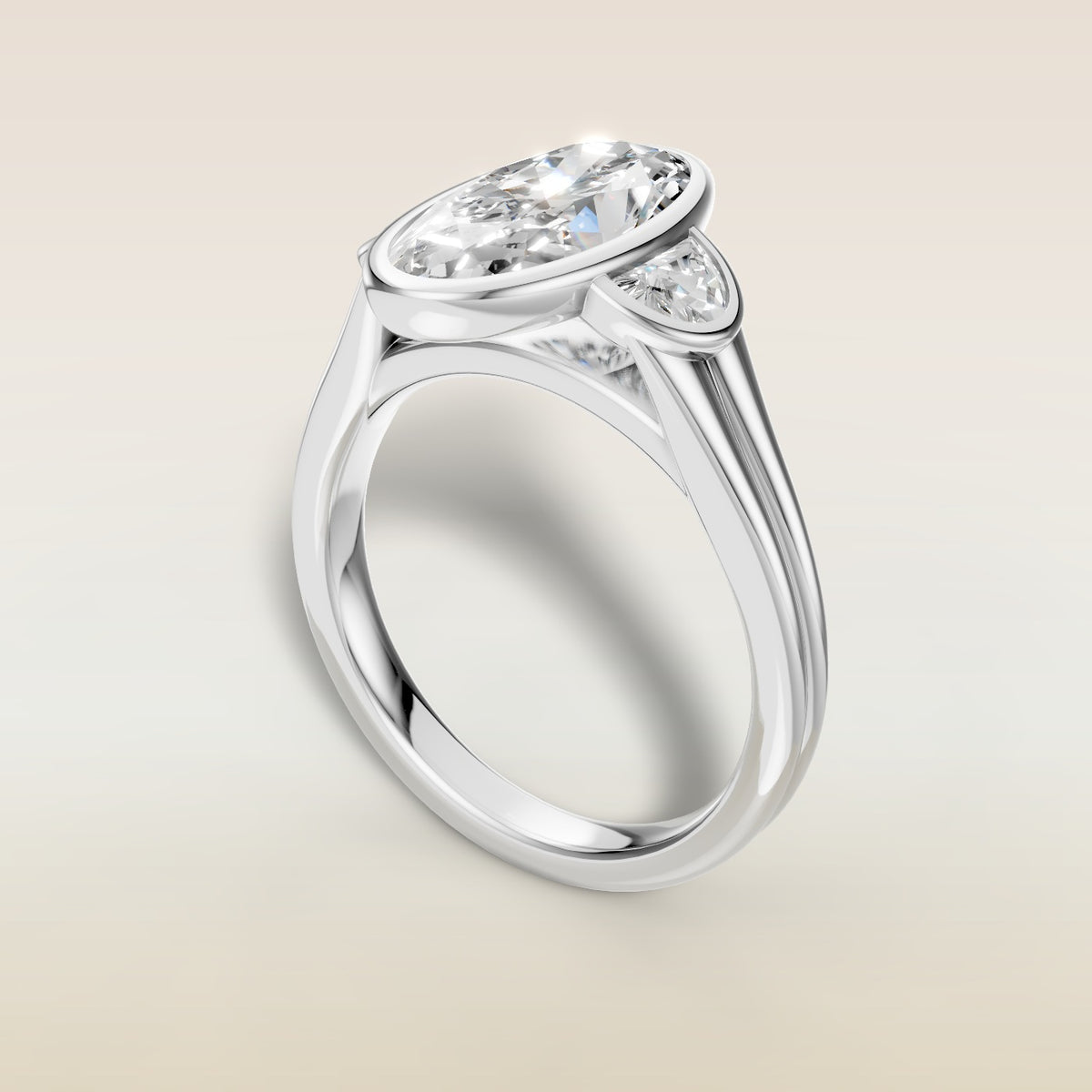 Moval Three Stone Full Bezel engagement ring in white gold, angled view