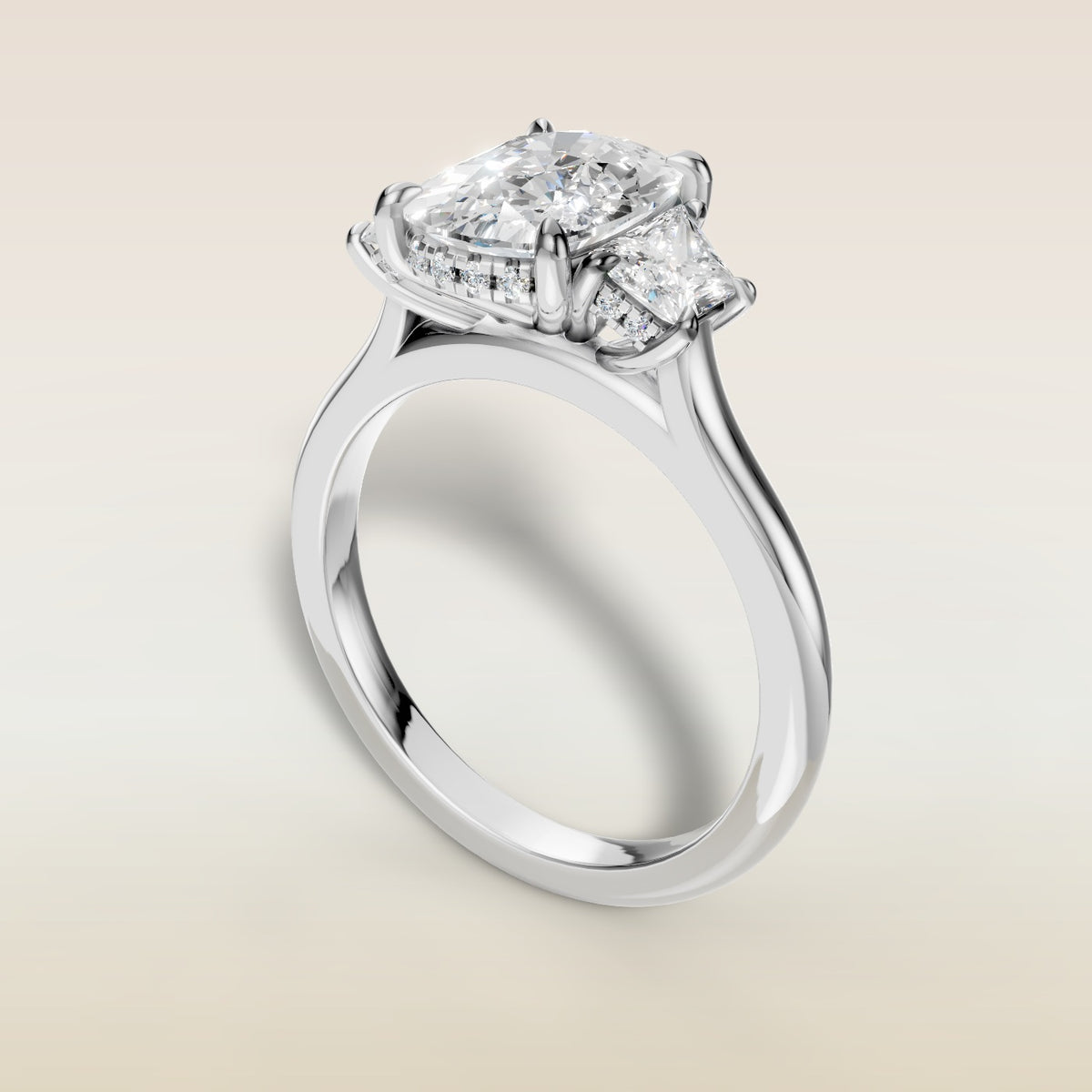Cushion Three Stone Hidden Halo engagement ring in white gold, angled view