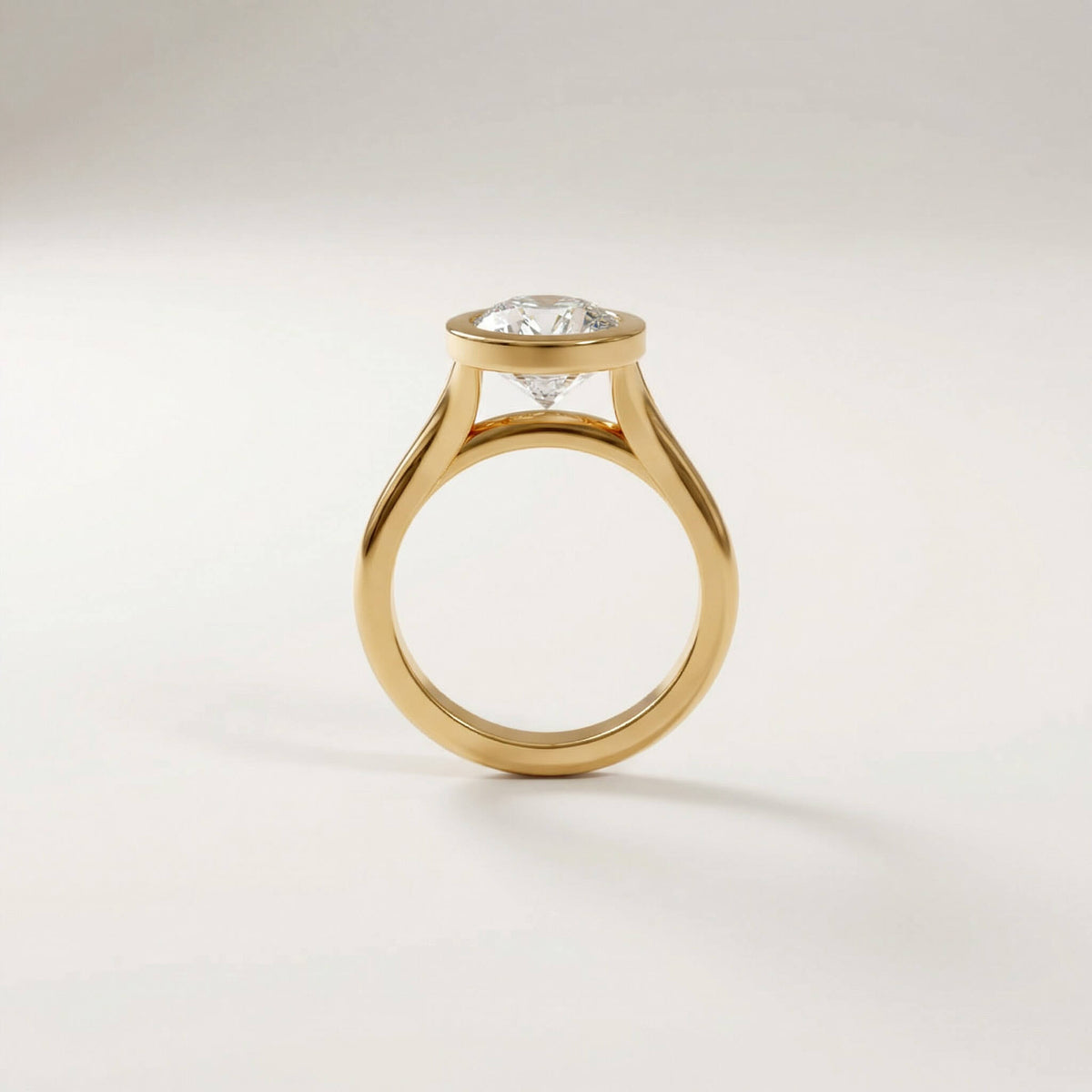 Full Bezel Split Shank engagement ring with a cushion diamond in yellow gold