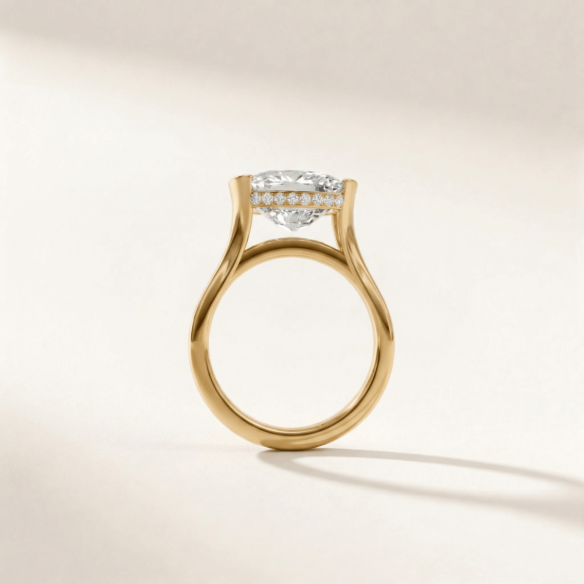 Half Bezel with Hidden Halo engagement ring with a cushion diamond in yellow gold