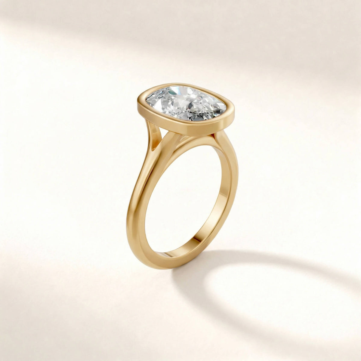 Full Bezel Split Shank engagement ring with a cushion diamond in yellow gold