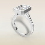 Emerald Full Bezel Split Shank engagement ring in white gold, angled view