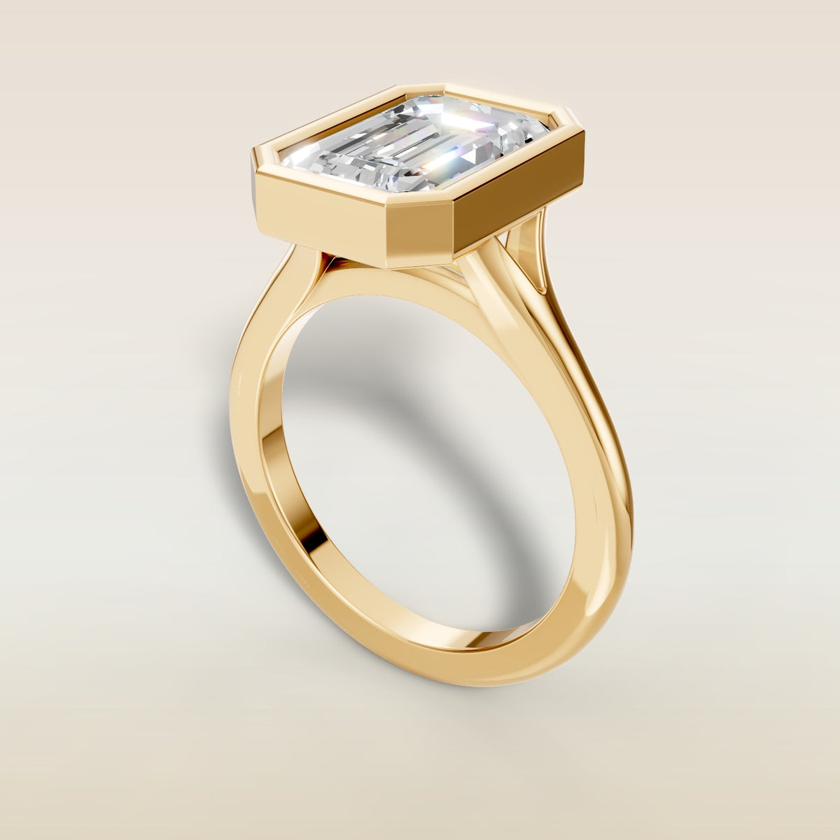 Emerald Full Bezel Split Shank engagement ring in yellow gold, angled view