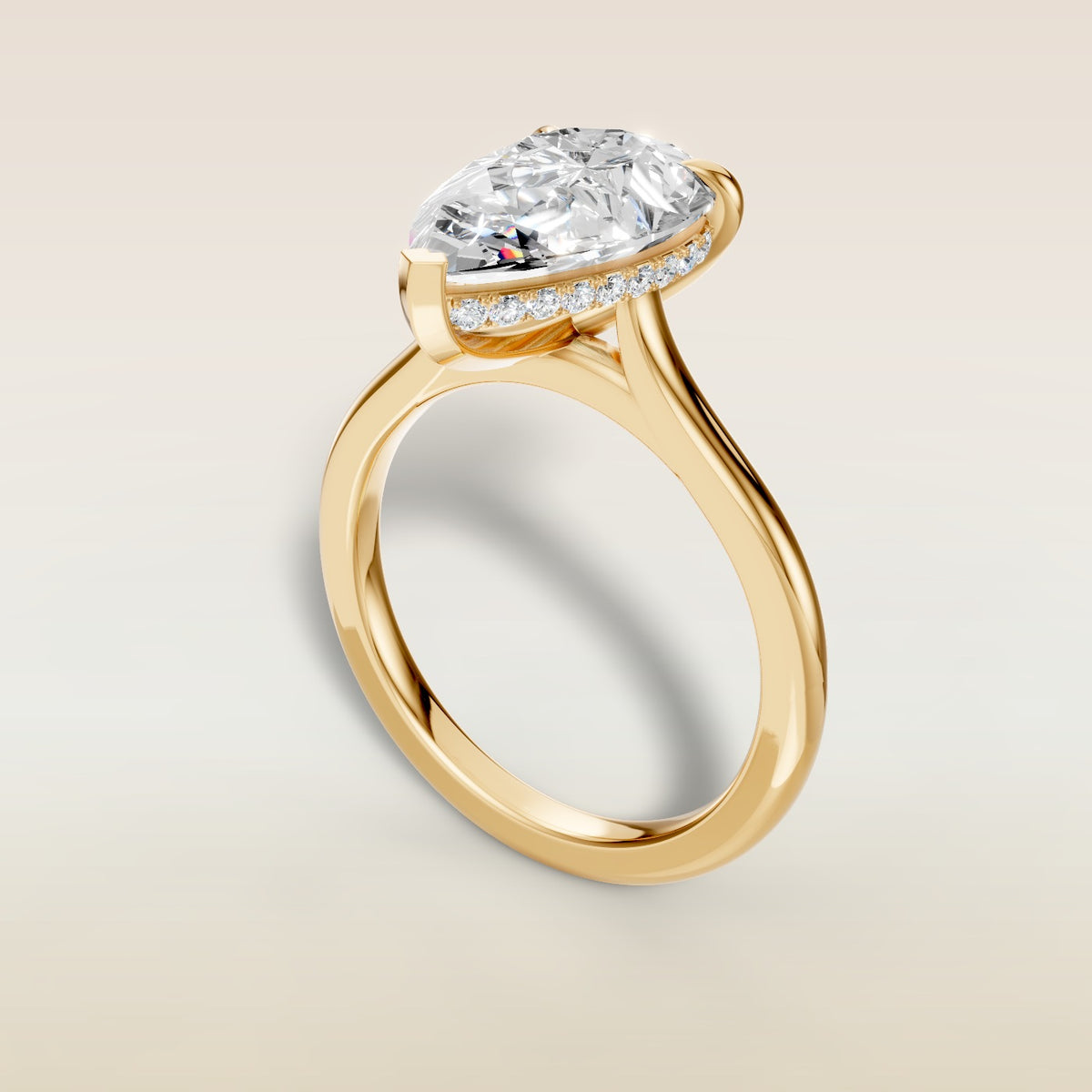 Pear Hidden Halo Cathedral engagement ring in yellow gold, angled view