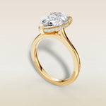 Pear Hidden Halo Cathedral engagement ring in yellow gold, angled view