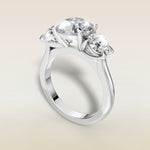 Round Three Stone engagement ring in white gold, angled view