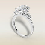 Oval Tulip Three Stone Hidden Halo engagement ring in white gold, angled view