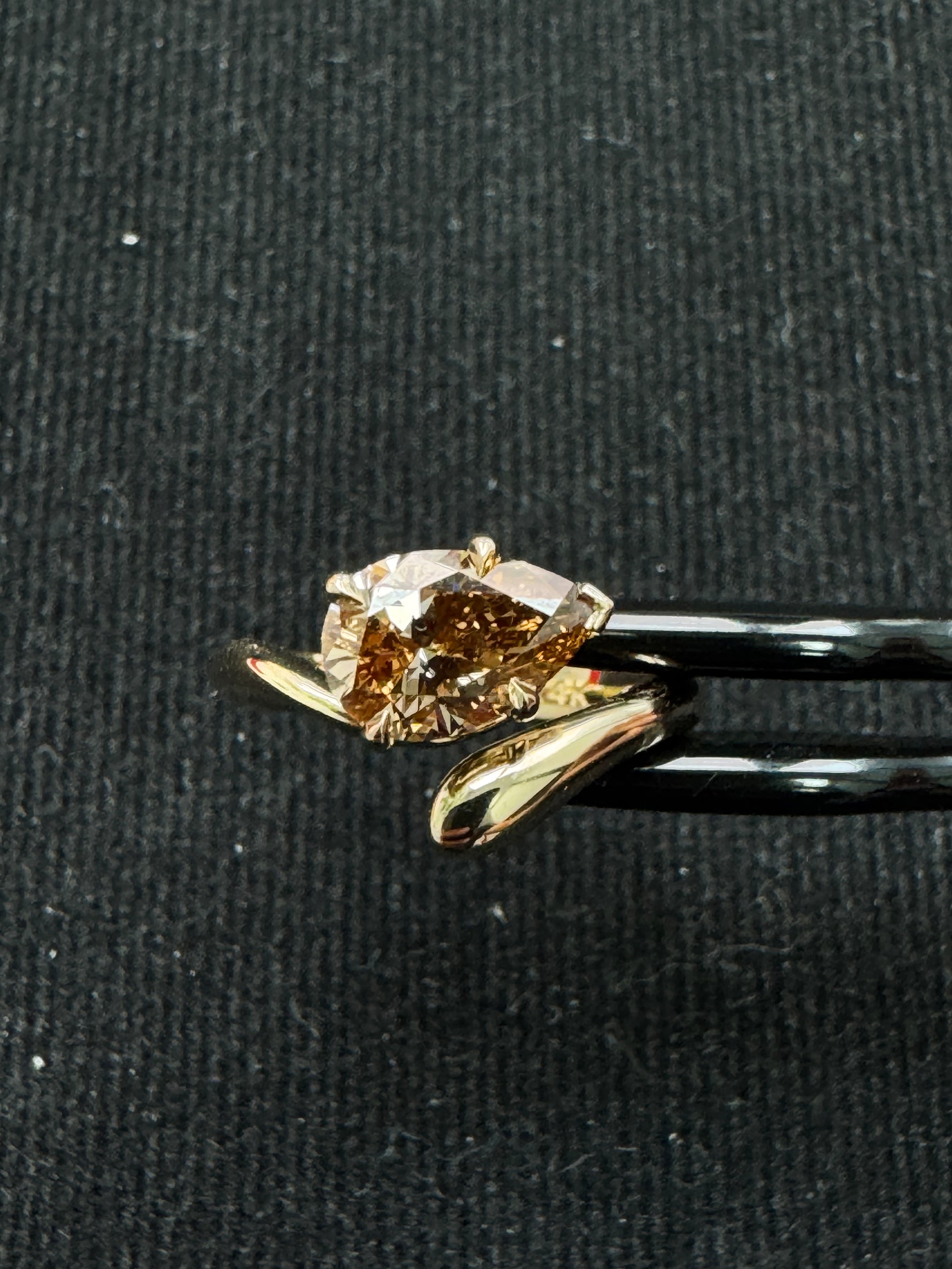 Pear champagne diamond ring detail view worn on hand