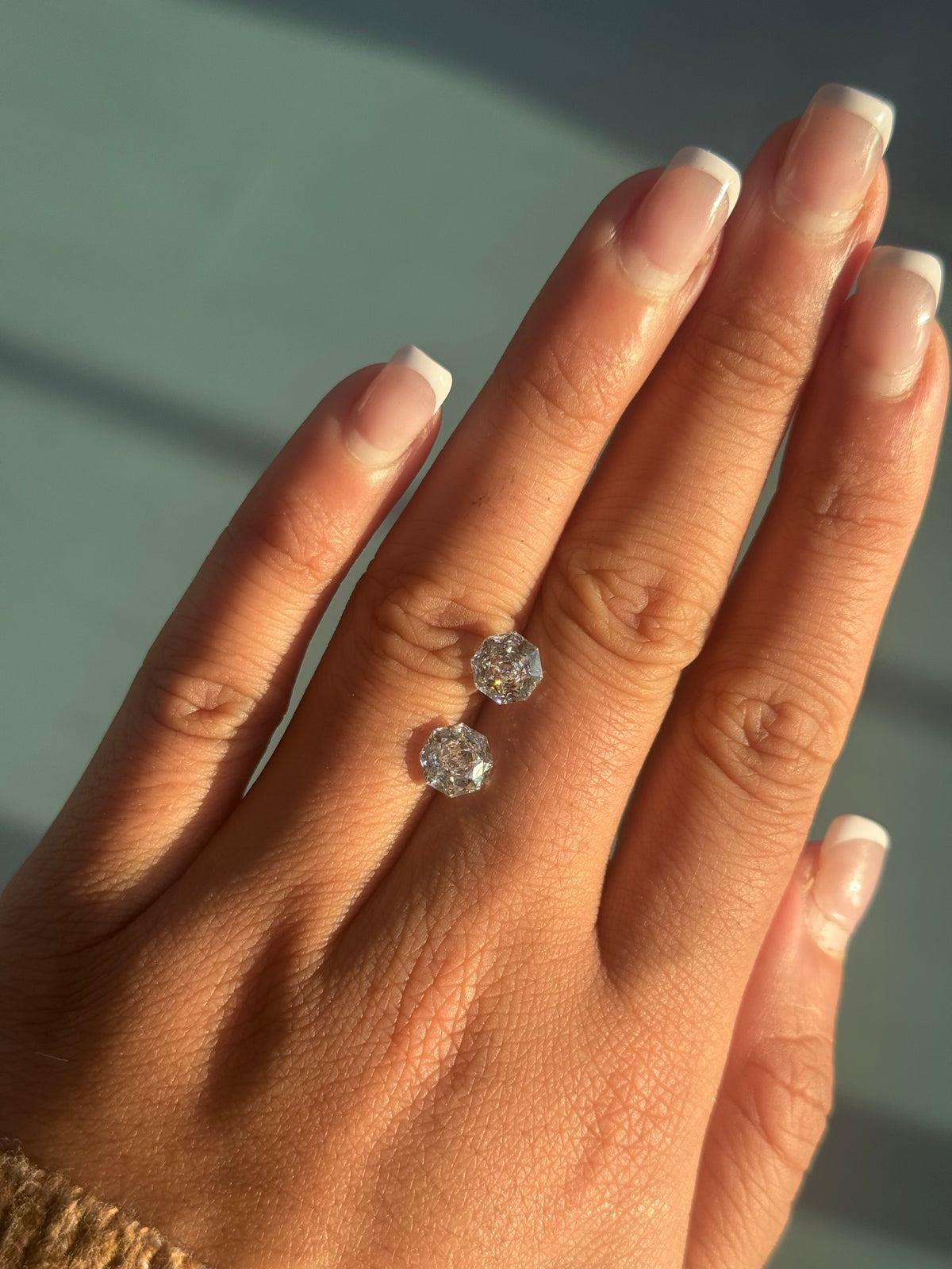 Pair of 1.5ct rose octagonal lab diamonds on the hand