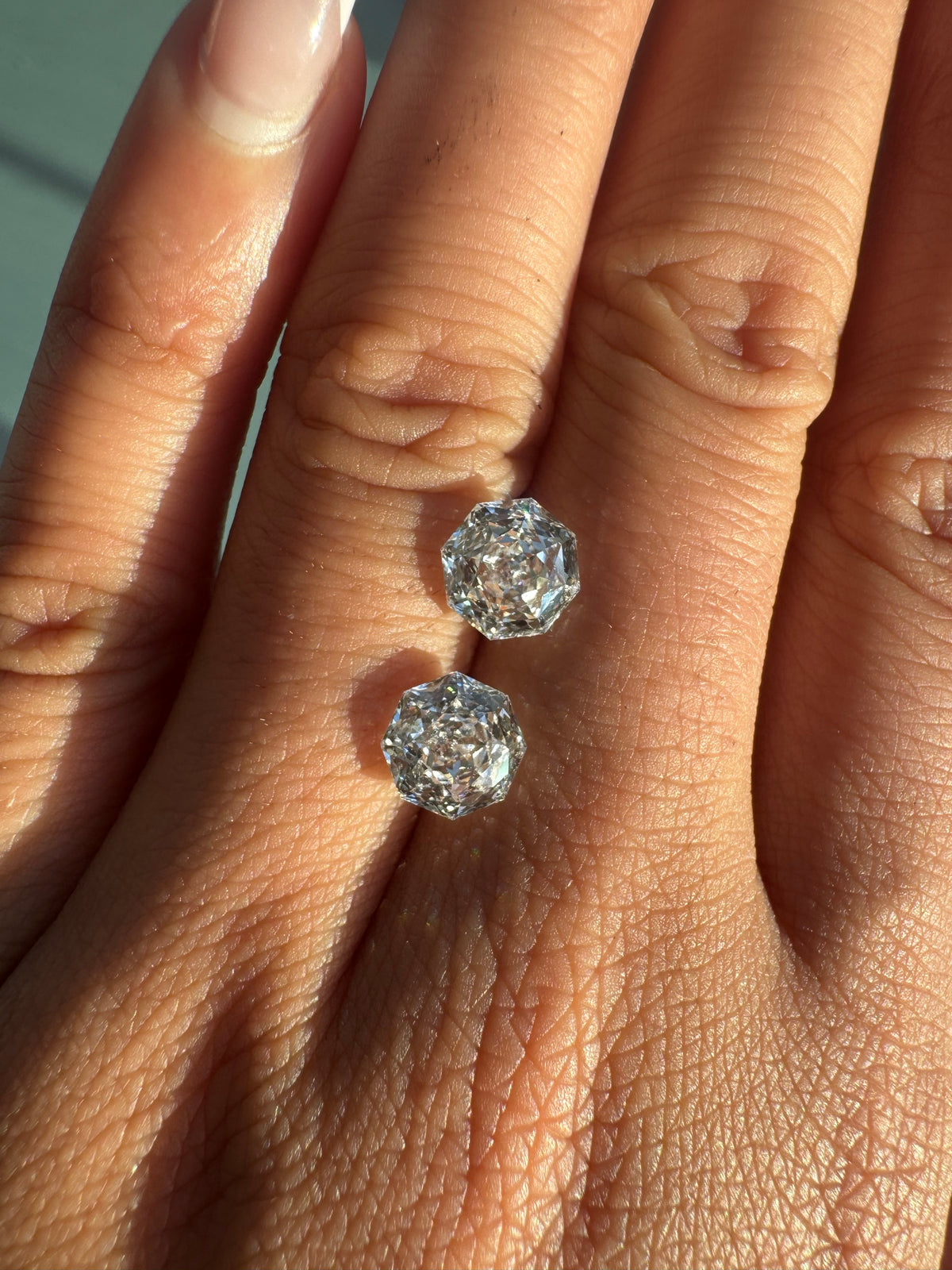 Pair of 2ct rose octagonal lab diamonds on the hand