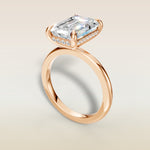 Emerald Hidden Halo Solitaire engagement ring in rose gold, angled view