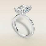 Emerald Hidden Halo Solitaire engagement ring in white gold, angled view