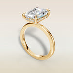 Emerald Hidden Halo Solitaire engagement ring in yellow gold, angled view