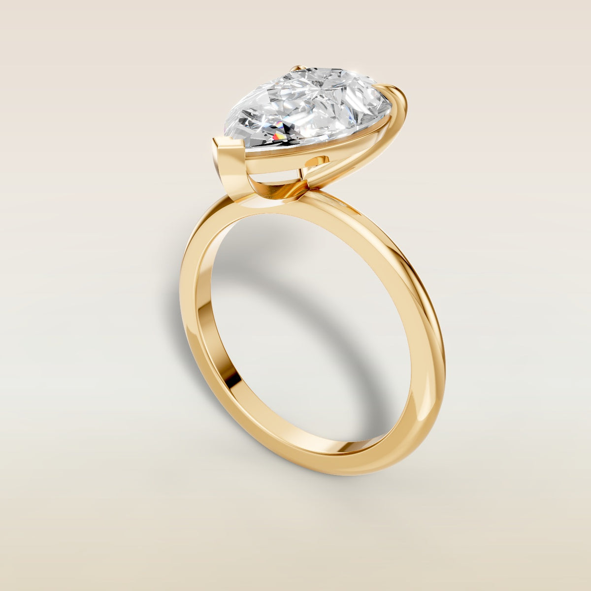 Pear Classic Solitaire engagement ring in yellow gold, angled view