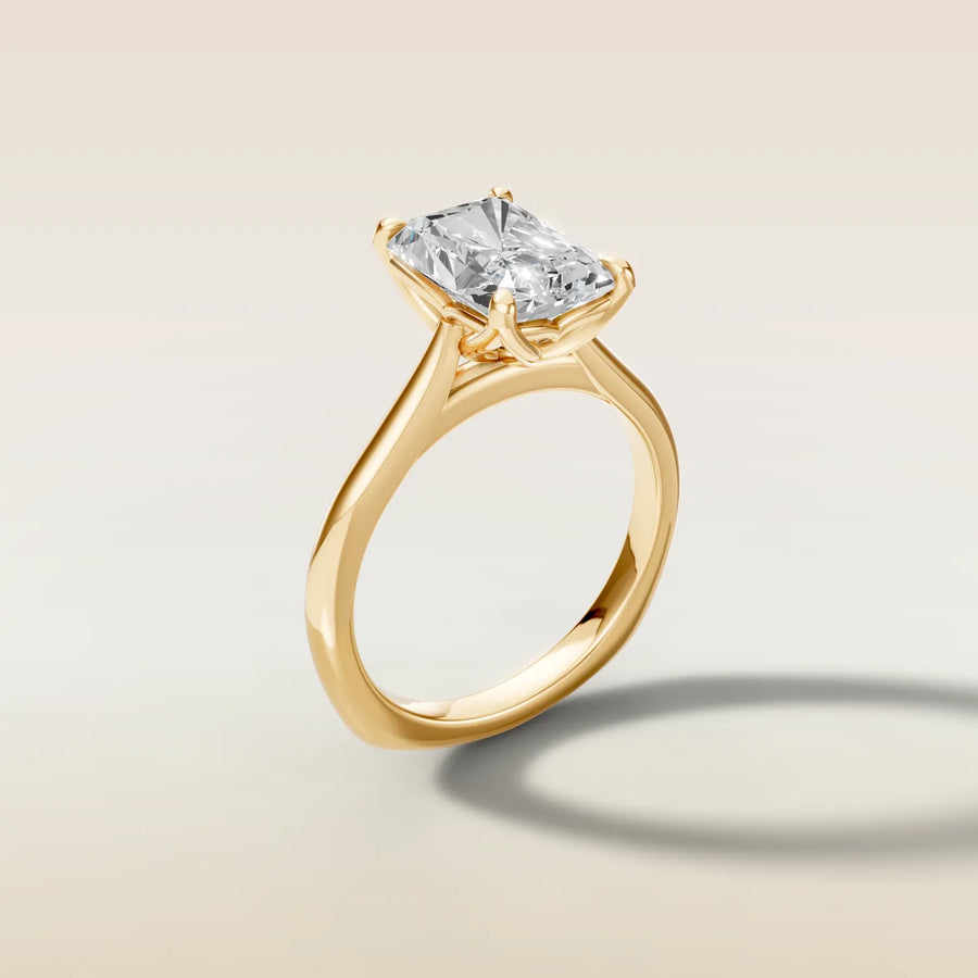 Radiant tulip engagement ring with curved gallery rail in yellow gold, side view
