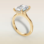 Emerald Hidden Halo Cathedral engagement ring in yellow gold, angled view