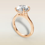 Round Hidden Halo Cathedral engagement ring in rose gold, angled view