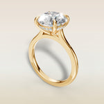 Round Hidden Halo Cathedral engagement ring in yellow gold, angled view