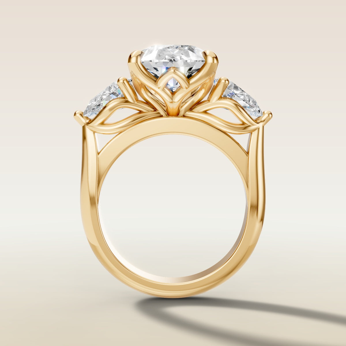 Pear Tulip Three Stone Diamond Bridge engagement ring in yellow gold, front view