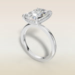 Radiant Hidden Halo Solitaire engagement ring in white gold, angled view