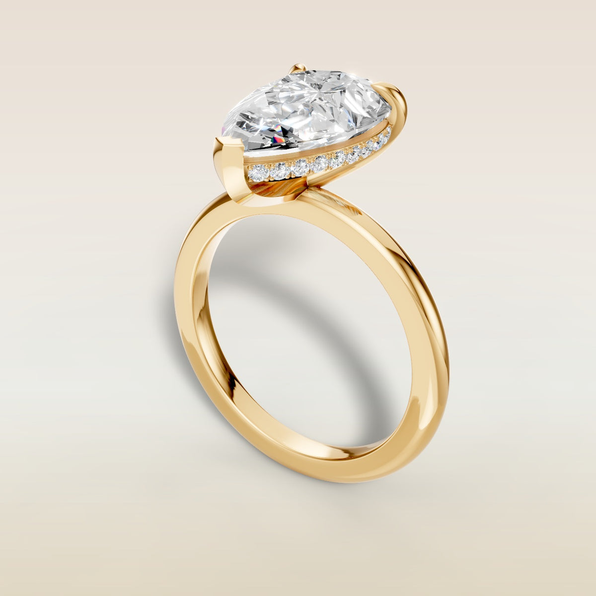 Pear Hidden Halo Solitaire engagement ring in yellow gold, angled view
