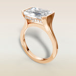 Emerald Half Bezel with Hidden Halo engagement ring in rose gold, angled view