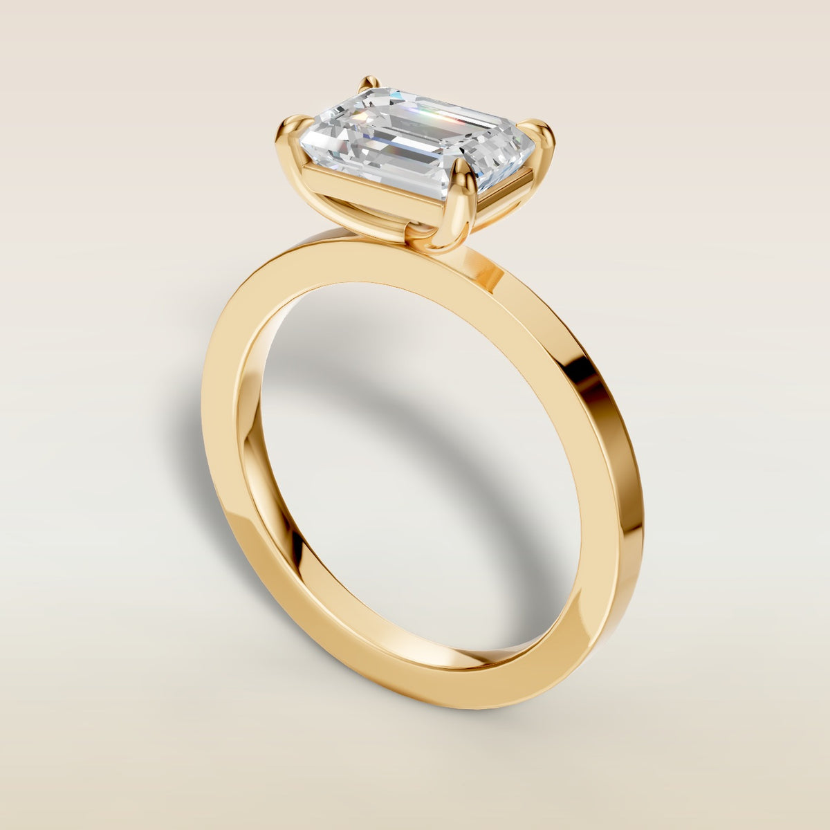 Emerald East West engagement ring in yellow gold, back angle
