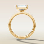 Emerald East West engagement ring in yellow gold, front view