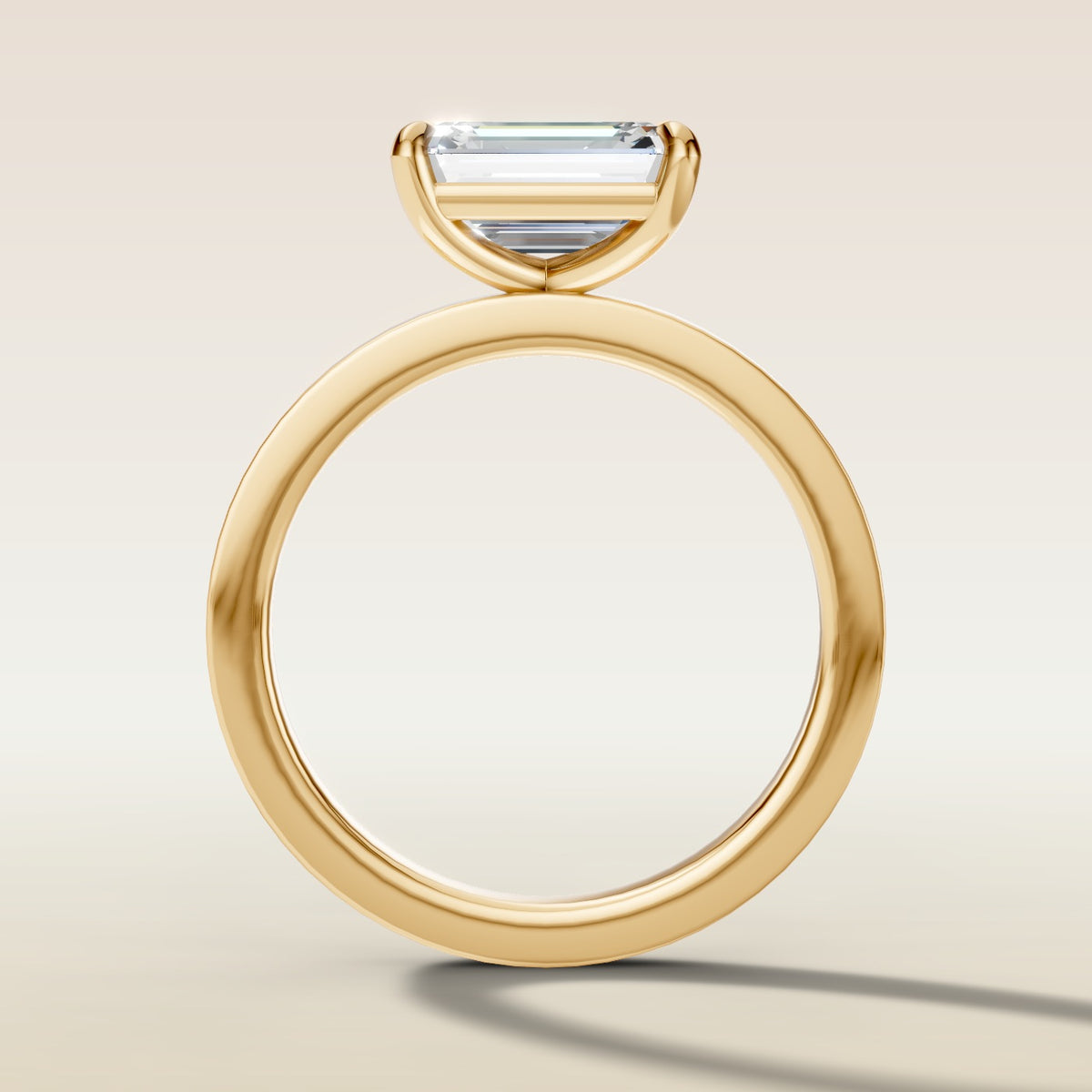Emerald East West engagement ring in yellow gold, front view