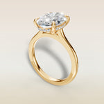Oval Hidden Halo Cathedral engagement ring in yellow gold, angled view