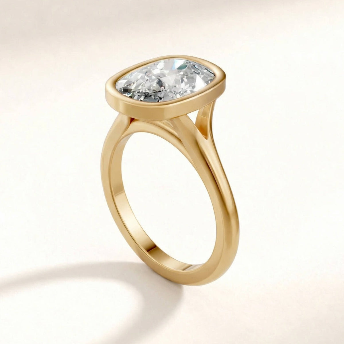 Full Bezel Split Shank engagement ring with a cushion diamond in yellow gold