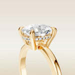 Cushion Low Profile Hidden Halo engagement ring in yellow gold, basket close up