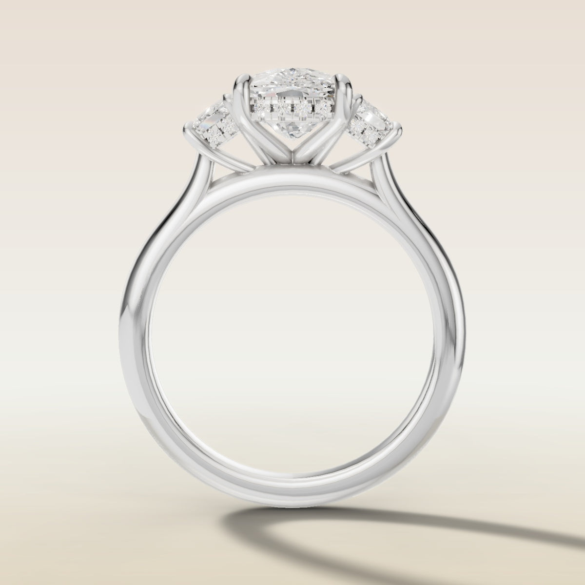 Cushion Three Stone Hidden Halo engagement ring in white gold, front view