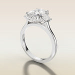 Cushion Three Stone Hidden Halo engagement ring in white gold, angled side view