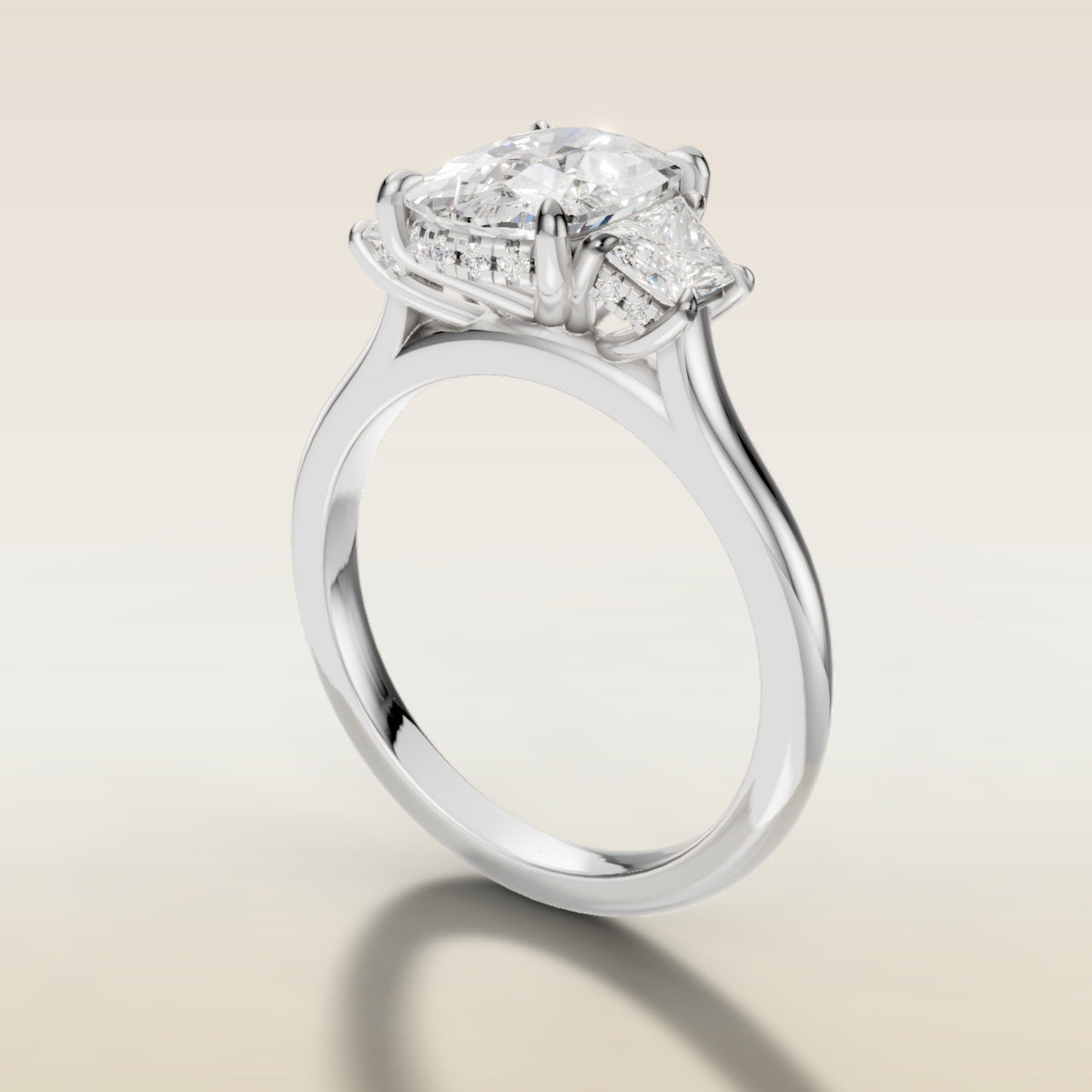 Cushion Three Stone Hidden Halo engagement ring in white gold, angled side view