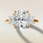 Cushion Three Stone Hidden Halo engagement ring in yellow gold, top view