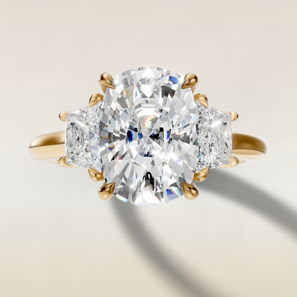 Cushion Three Stone Hidden Halo engagement ring in yellow gold, top view