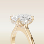 Cushion Tulip Curved Hidden Halo Double Prong engagement ring in yellow gold, basket close up