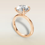 Round Hidden Halo Solitaire engagement ring in rose gold, angled view