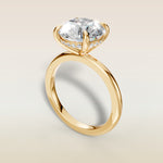 Round Hidden Halo Solitaire engagement ring in yellow gold, angled view