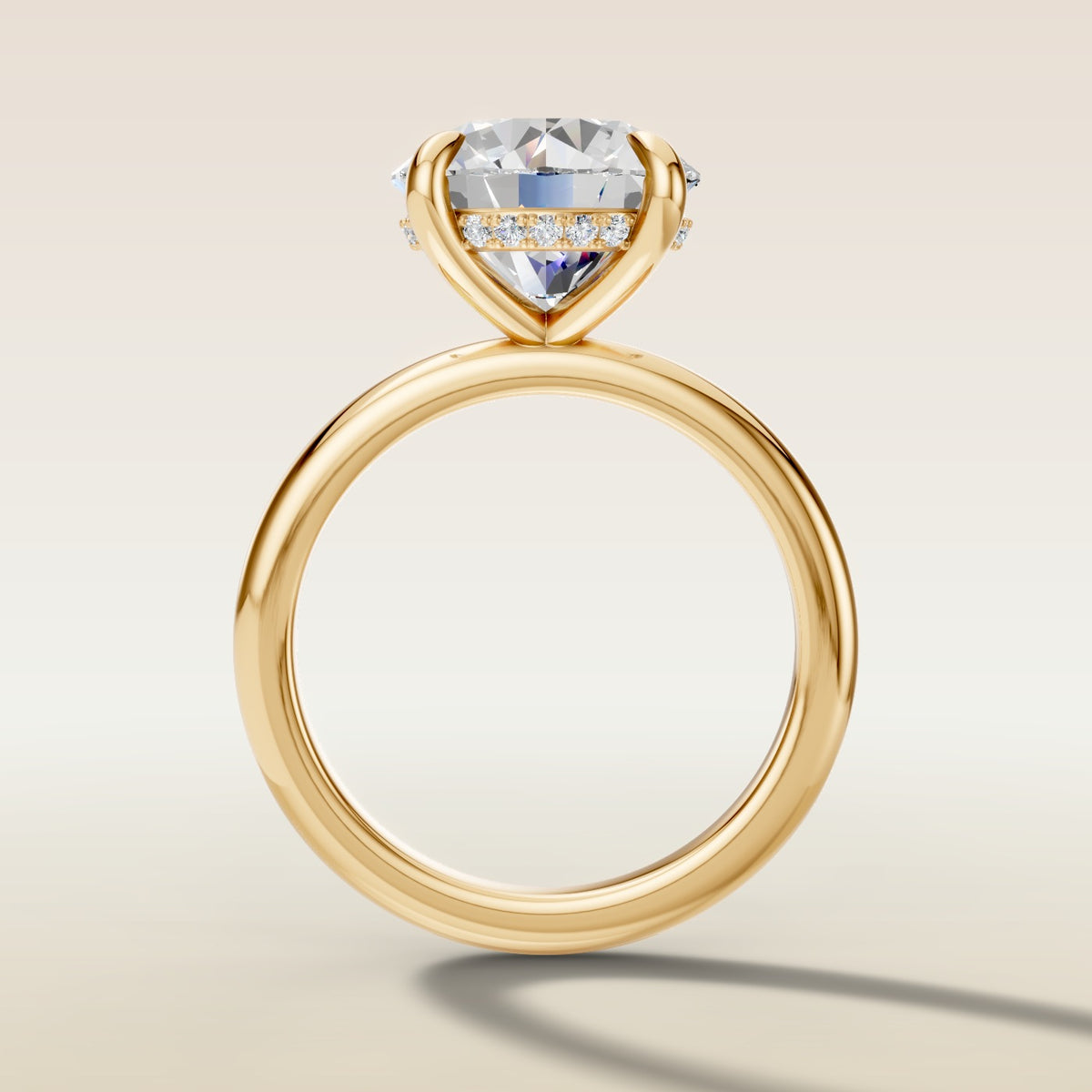 Round Hidden Halo Solitaire engagement ring in yellow gold, front view
