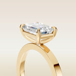 Emerald East West engagement ring in yellow gold, basket close up