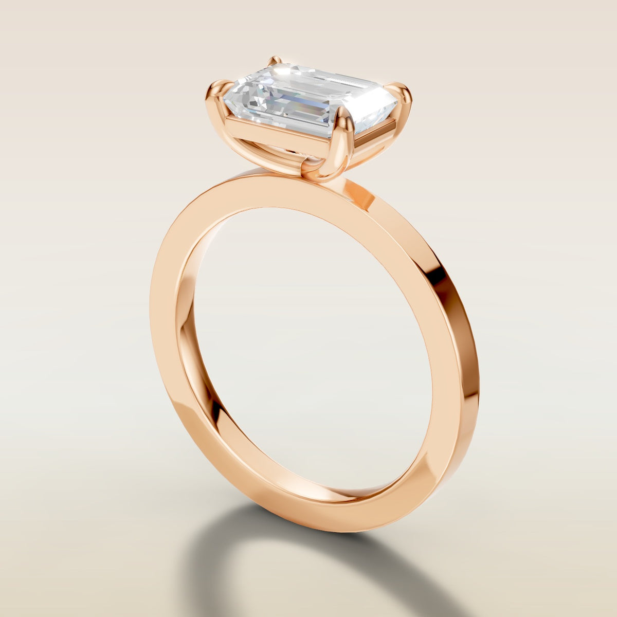 Emerald East West engagement ring in rose gold, angled side view
