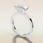 Emerald East West engagement ring in white gold, angled side view