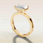 Emerald East West engagement ring in yellow gold, angled side view