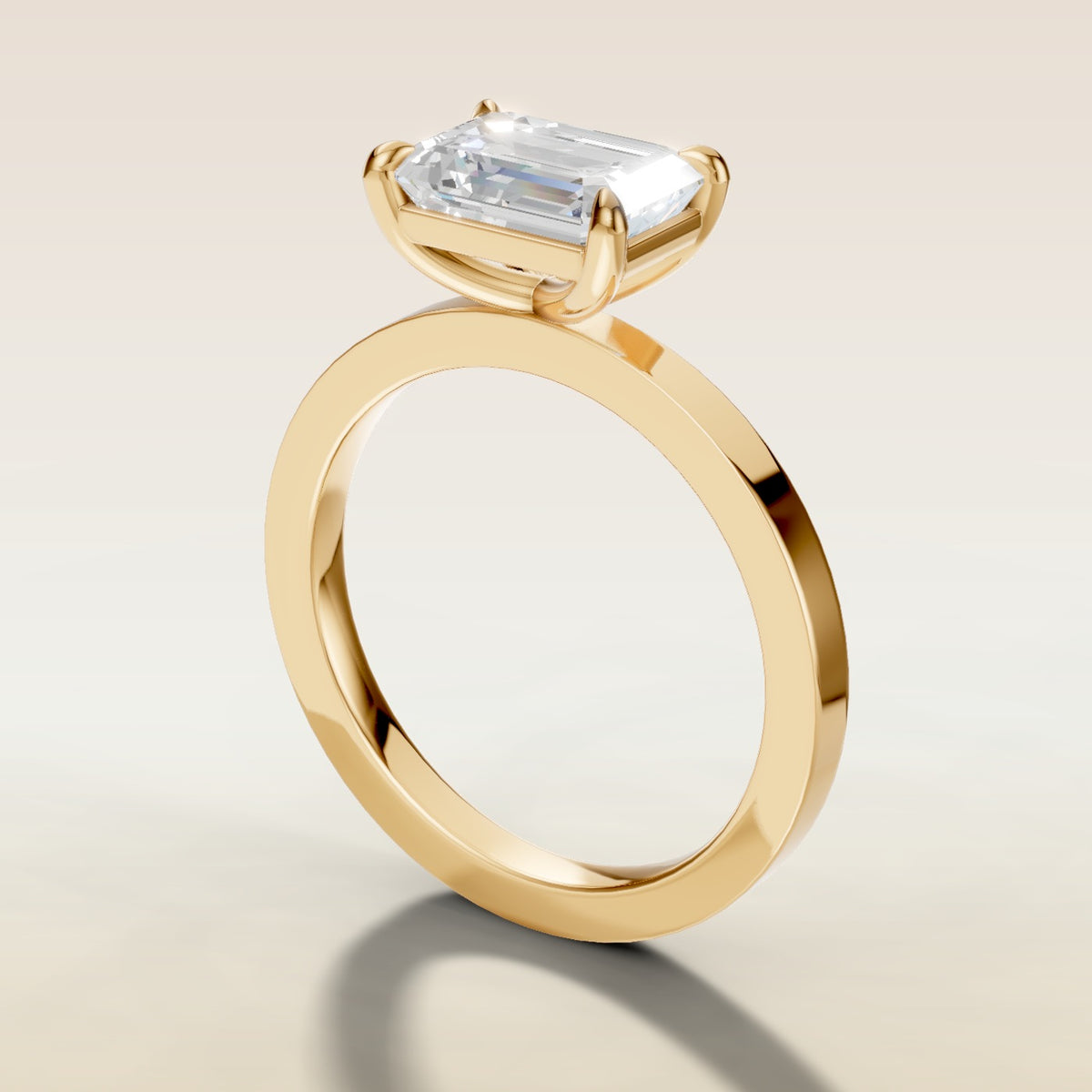 Emerald East West engagement ring in yellow gold, angled side view