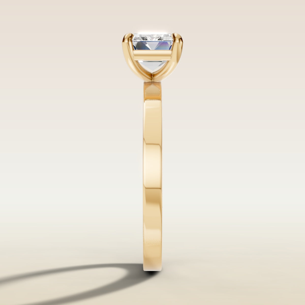 Emerald East West engagement ring in yellow gold, side profile