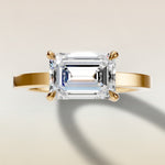 Emerald East West engagement ring in yellow gold, top view