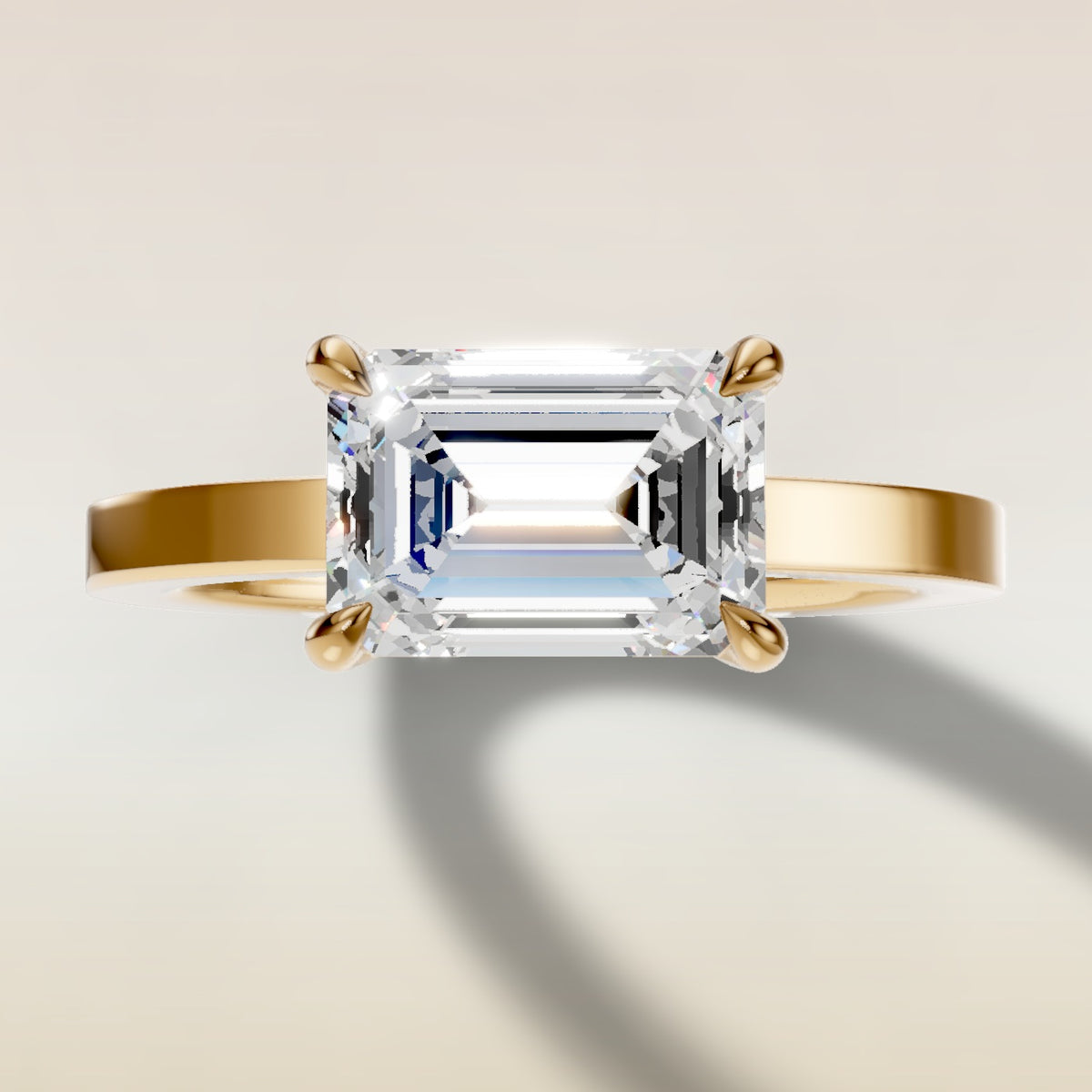 Emerald East West engagement ring in yellow gold, top view